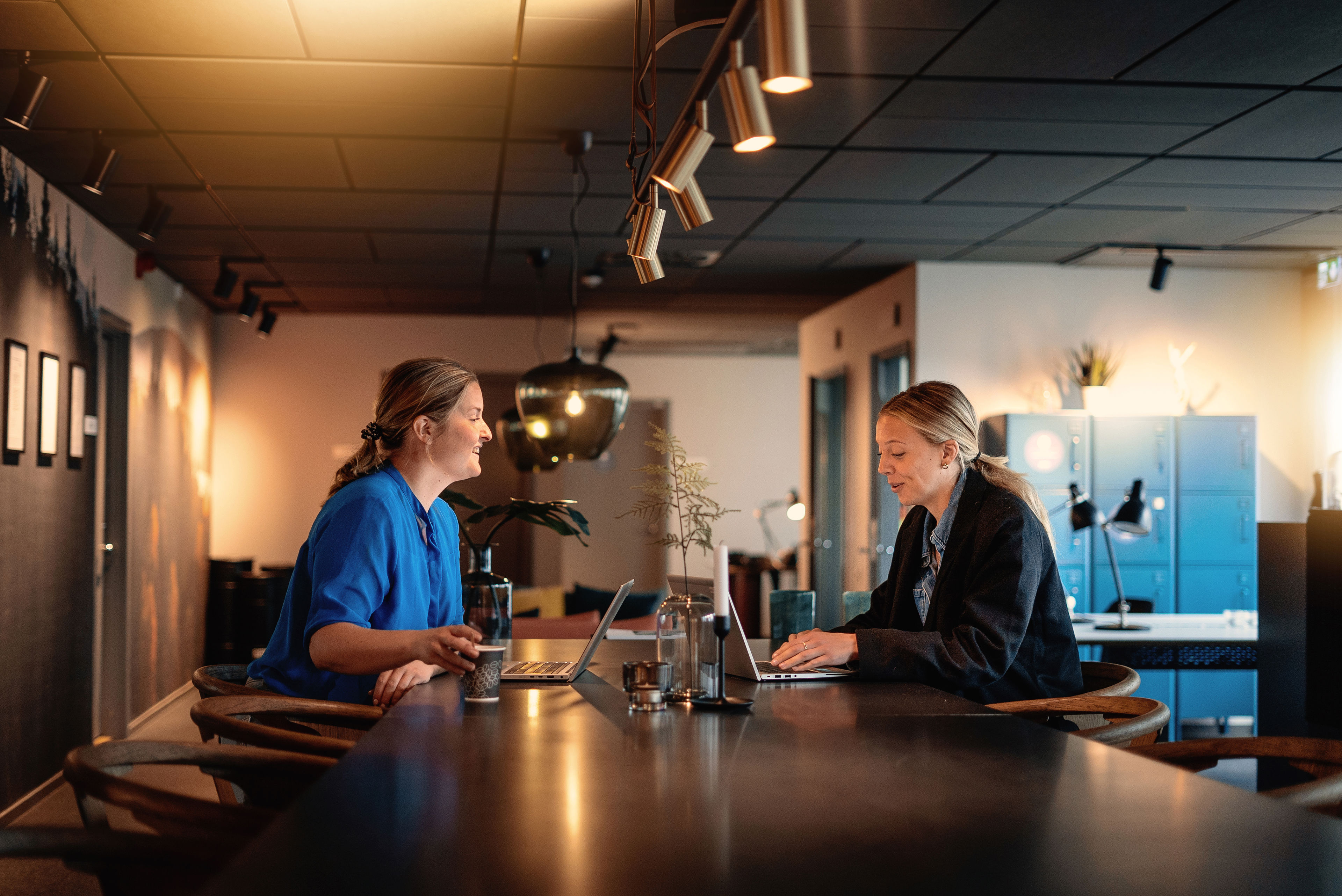 Two female Stena Recycling colleagues work together on their laptops