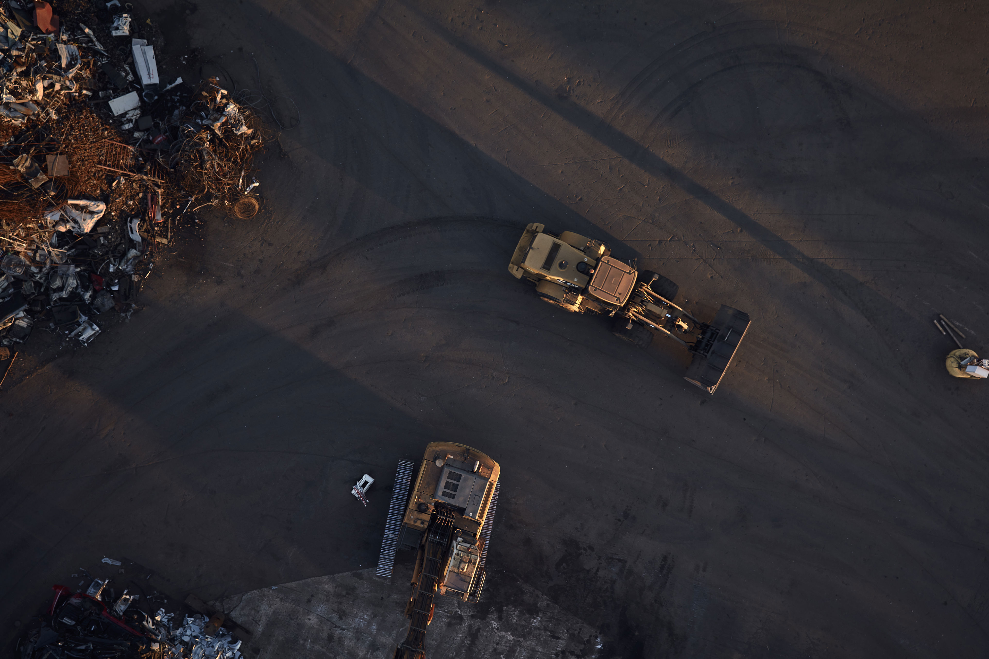 An aerial shot of a digger working in a scrap yard