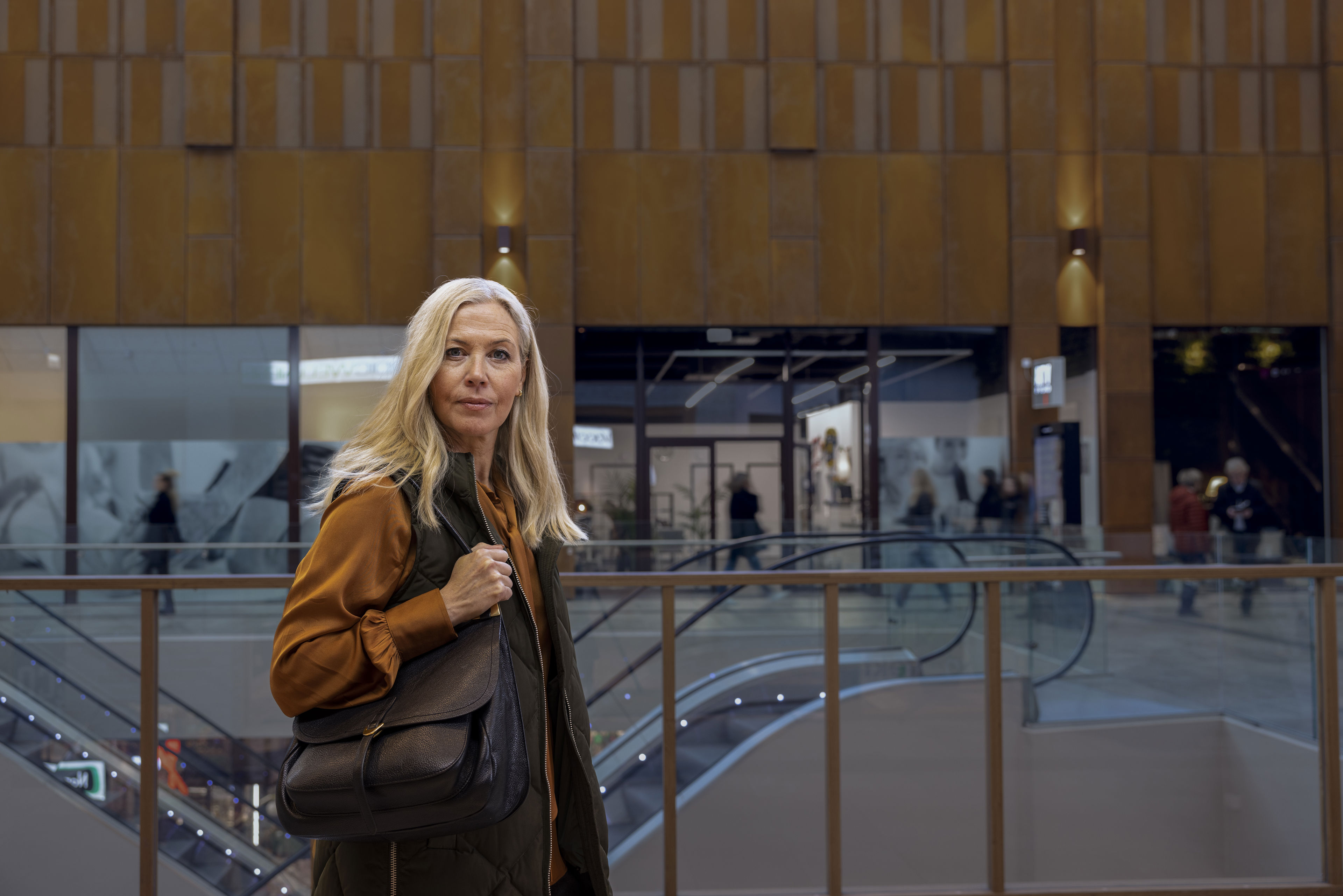 Kobieta biorąca udział w ankiecie Circular Voice stoi w centrum handlowym.