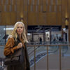 A female participant in the Circular Voice survey  stands in a shopping centre.