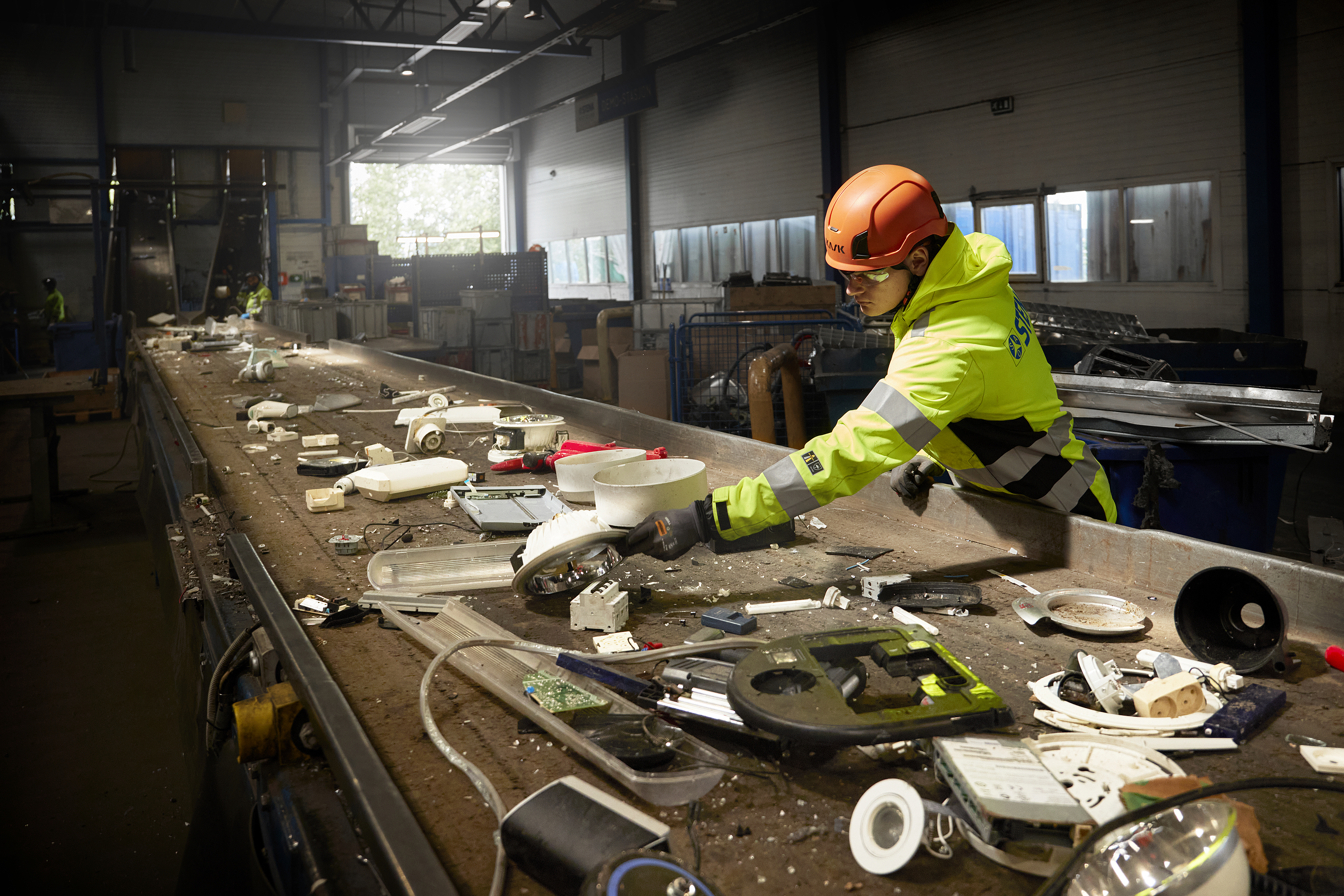 A female Stena Recycling expert sorts electronic waste by hand at Stena Nordic recycling Center.