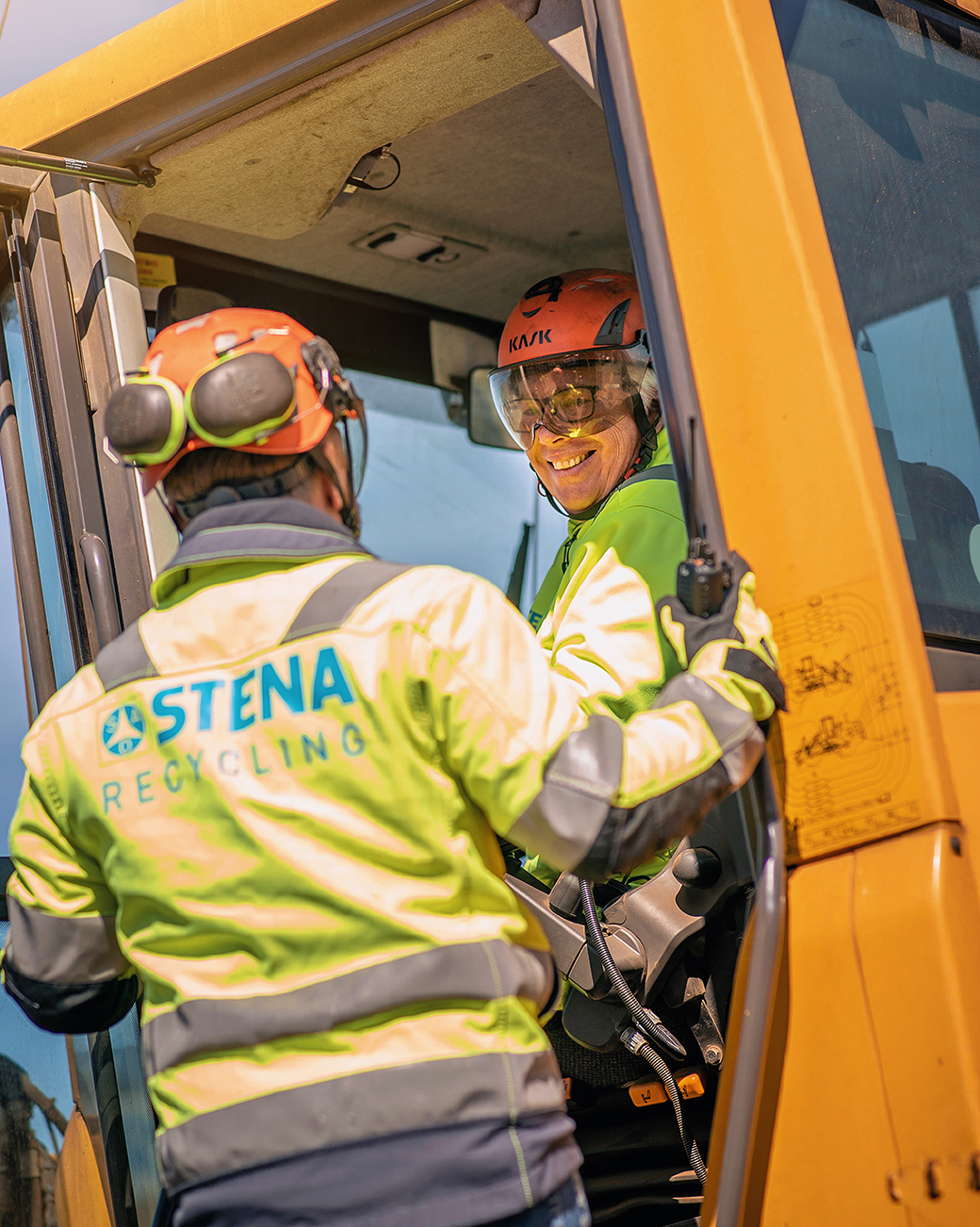 Two demolition experts dressed in hardhats and protective jackets