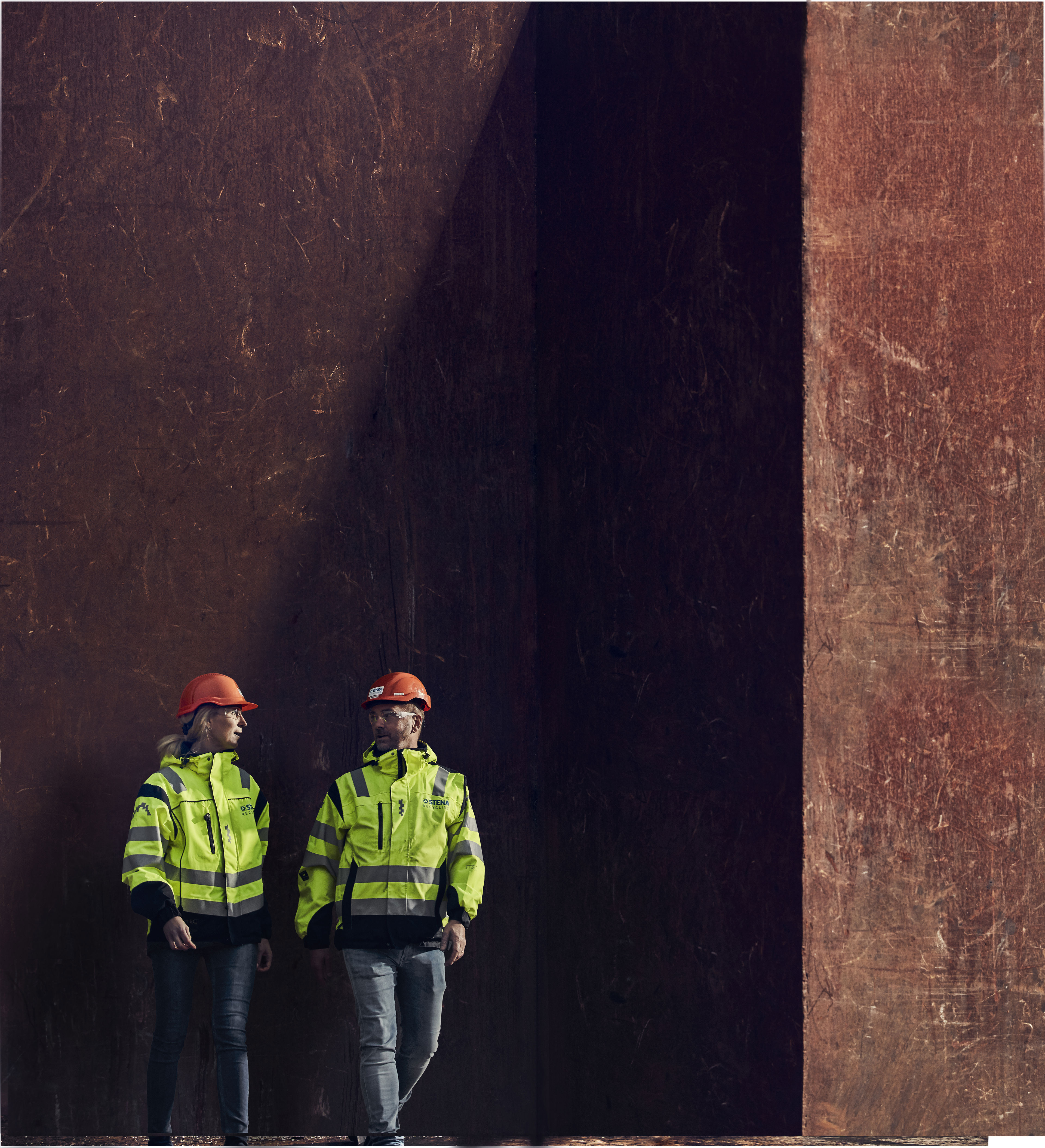 Two Stena Recycling experts - one male and one female - in hi-vis protective clothing