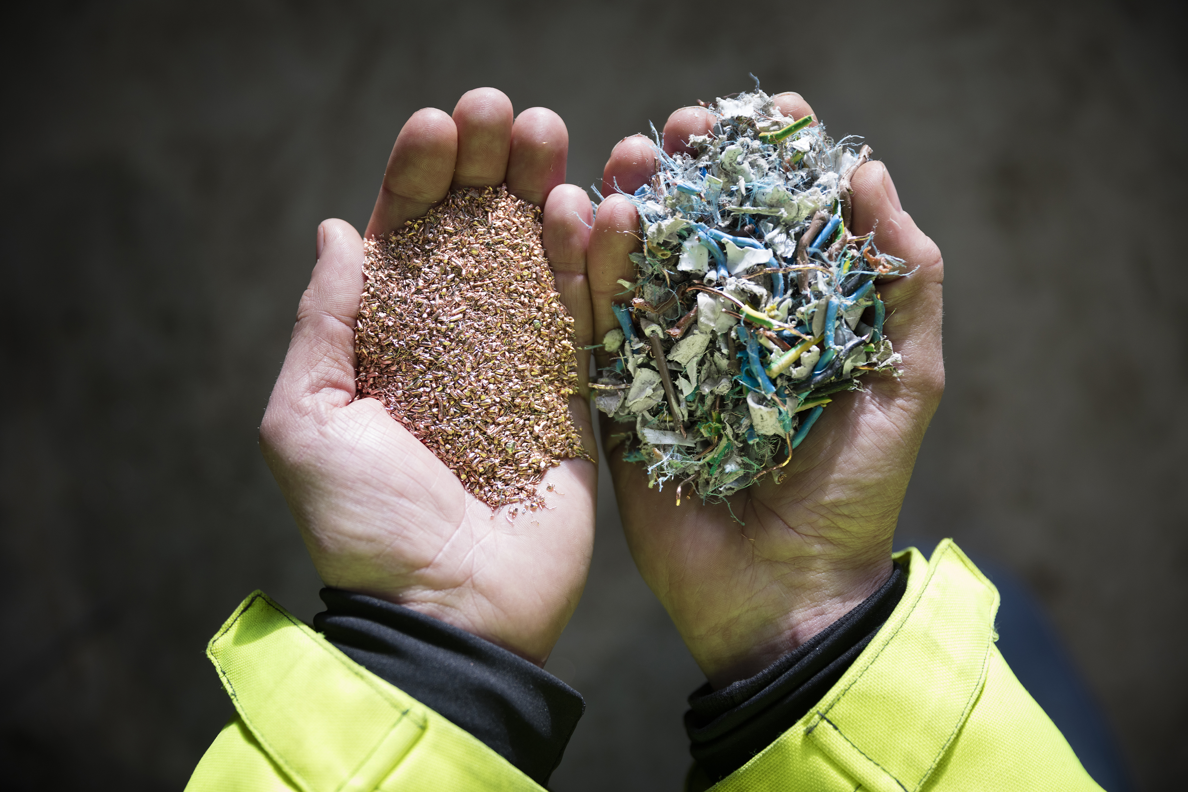 A close-up of a Stena Recycling expert's hands as they hold material ready for recycling.
