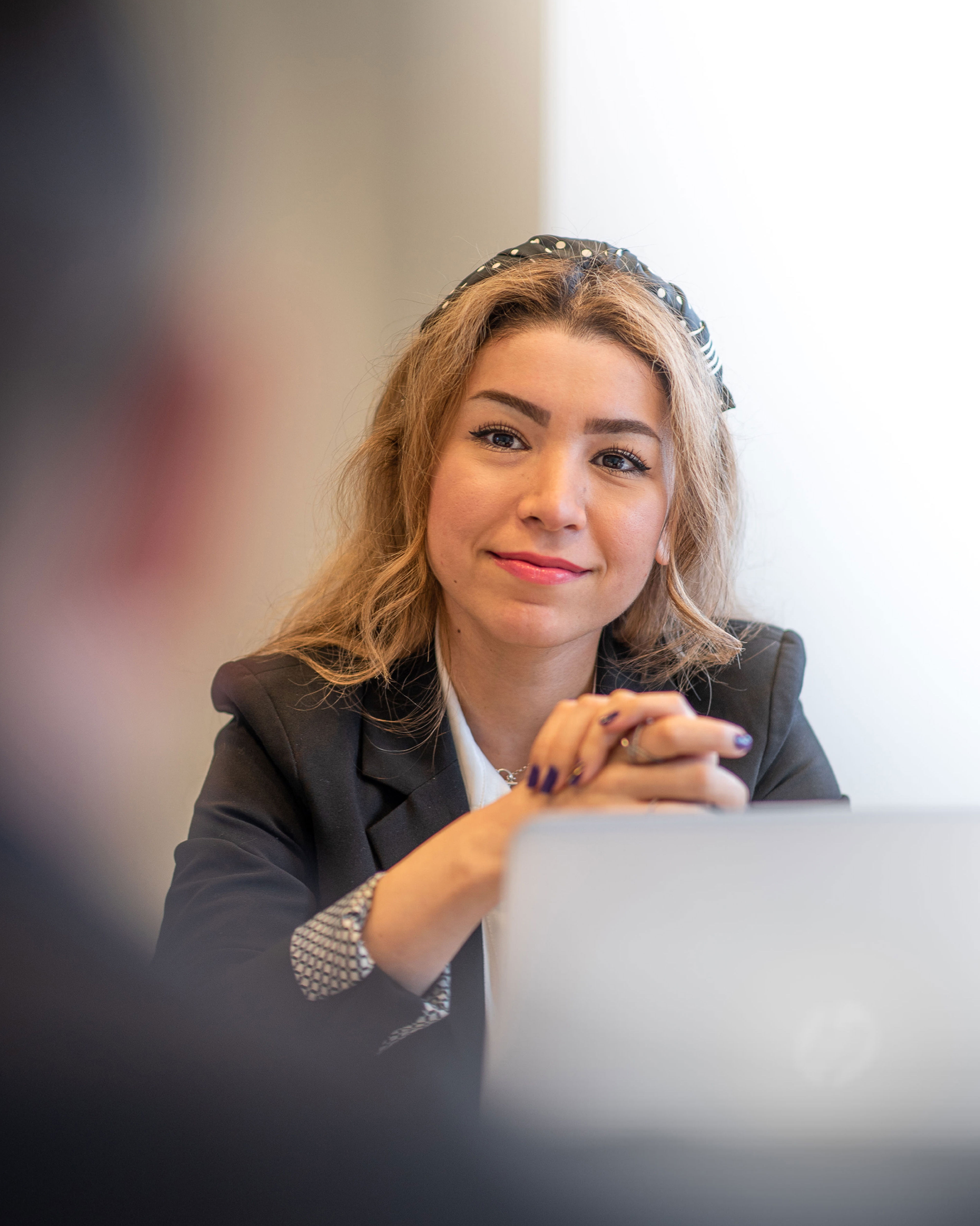 A blonde female recycling expert looking into the camera, smiling.