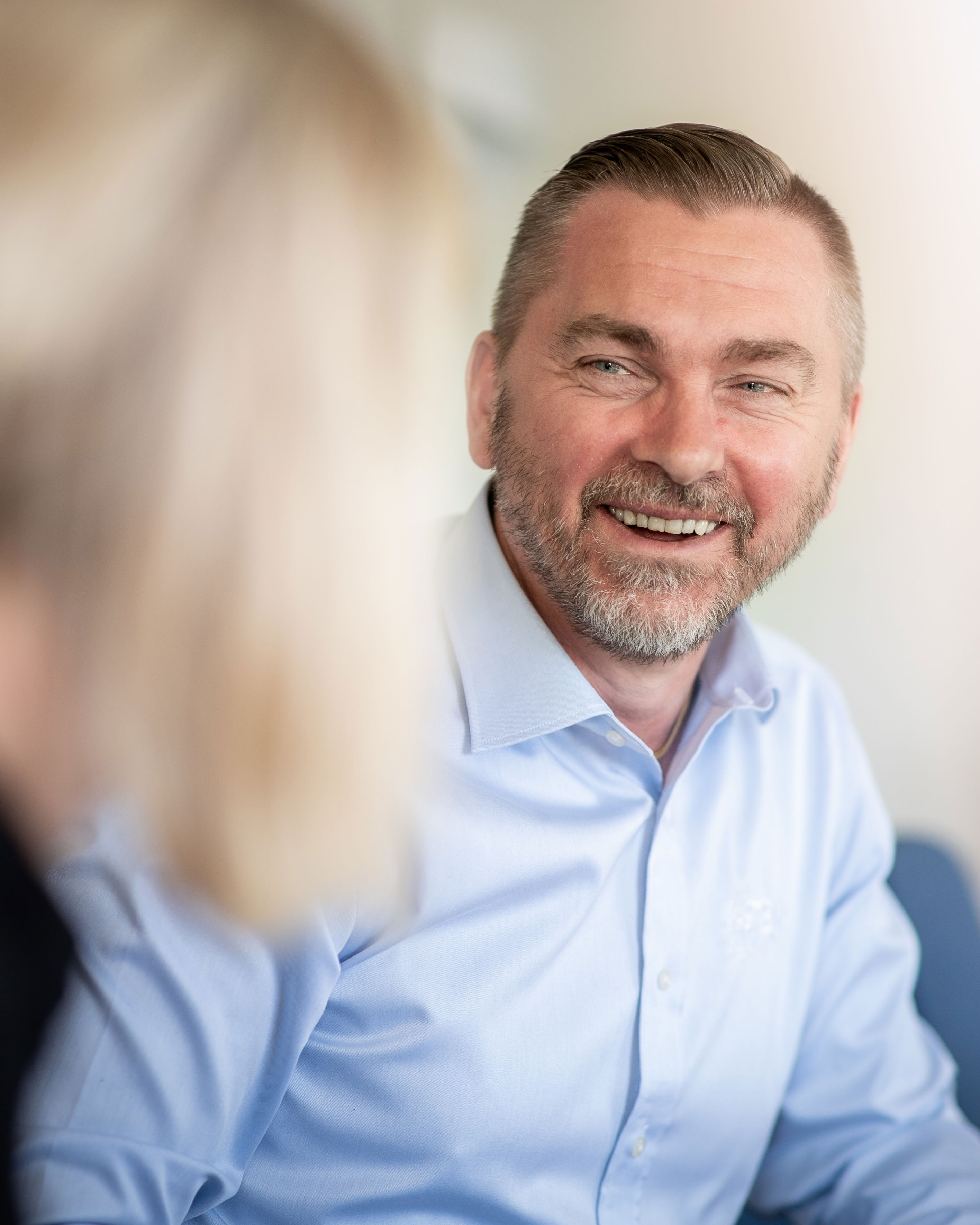 A male Stena Recycling employee smiles in an office.