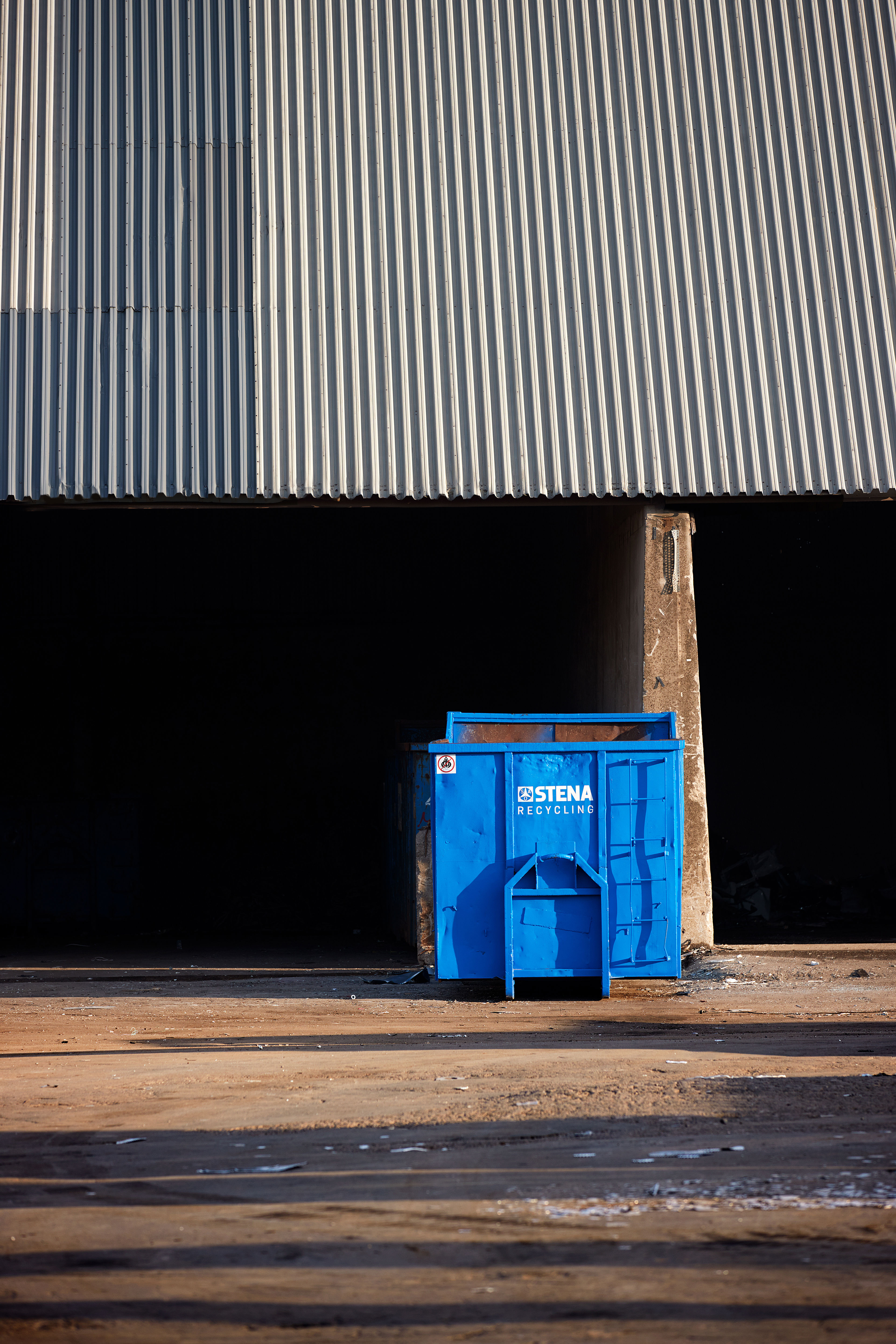 Large blue steel container with Stena Recycling logotype, placed in a factory yard